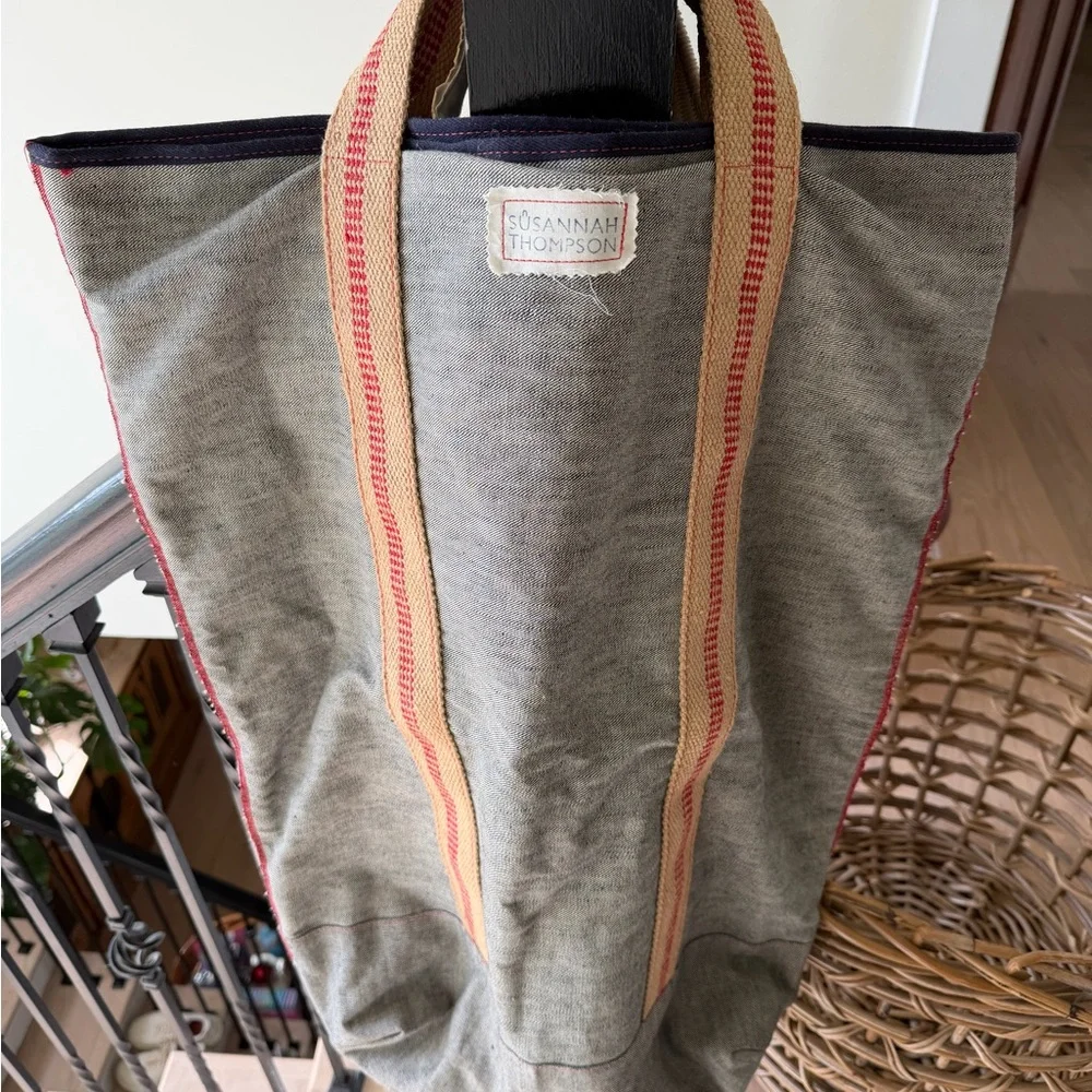 Susannah Thompson Laundry Tote. Gray, tan natural fiber, red-trim handles.